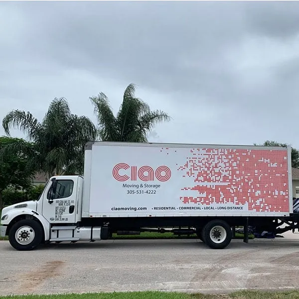 Side view of a Ciao Moving & Storage box truck with phone number and website