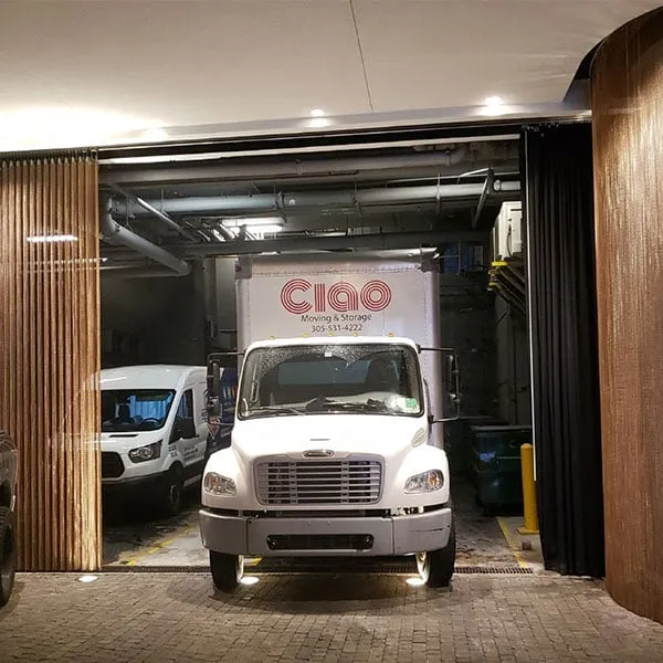 Ciao Moving & Storage truck pulling out of a covered loading dock