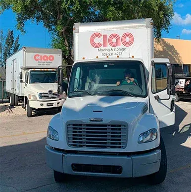 Front view of a Ciao Moving & Storage truck with a second truck behind